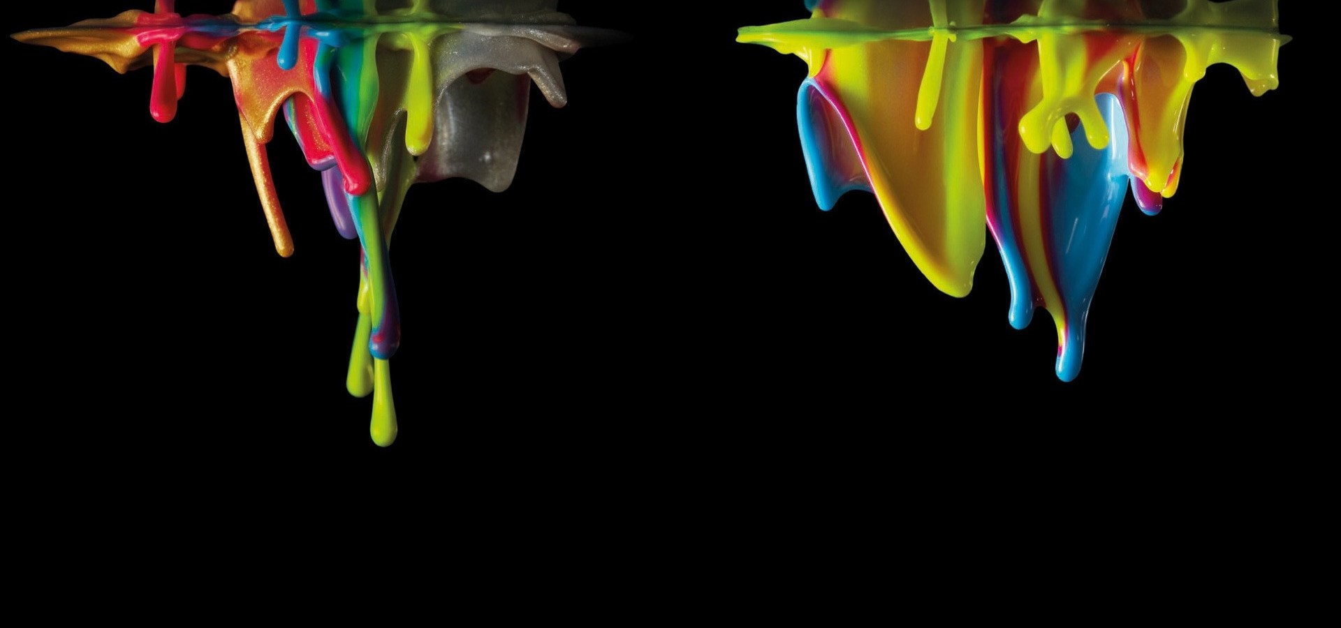 Dark background with rainbow paint spilling in from top